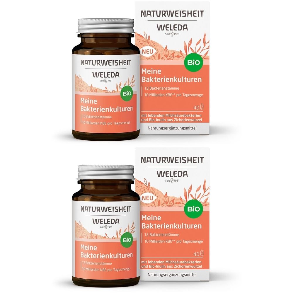 Zwei braune Glasflaschen und zwei Kartons. Aufschrift: Meine Bakterienkulturen, Bio-Siegel, Marke Weleda.