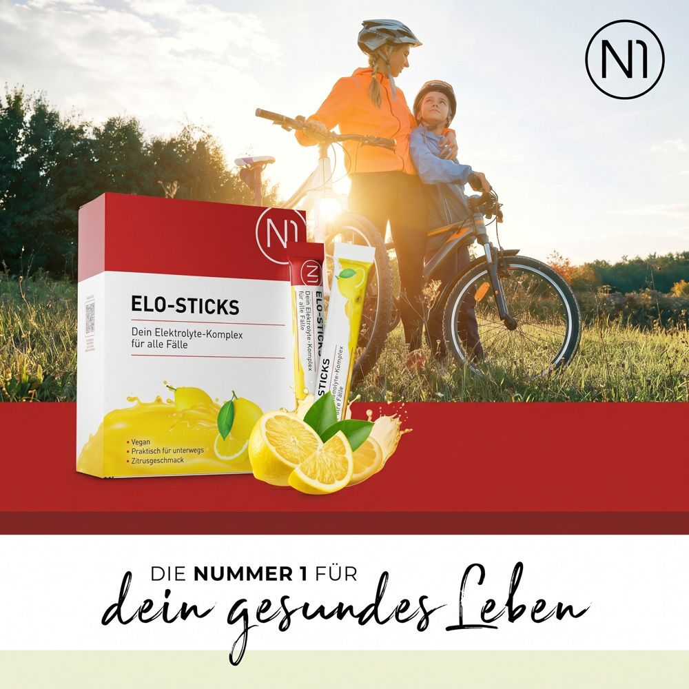 N1 Elo-Sticks Packung und Stick mit Zitronen-Design. Mutter und Kind auf Fahrrädern im Hintergrund.