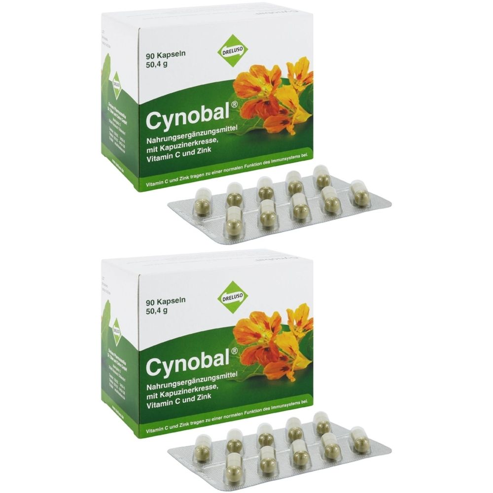 Zwei Schachteln und Blisterpackungen mit Kapseln. Auf den Schachteln steht "Cynobal" und "90 Kapseln".