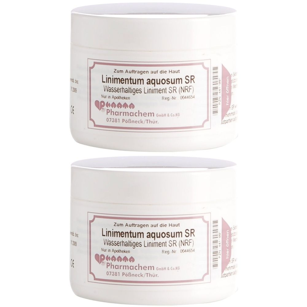 Zwei weiße Tiegel mit Deckel. Auf dem Etikett steht: Linimentum aquosum SR. Text in deutscher Sprache.