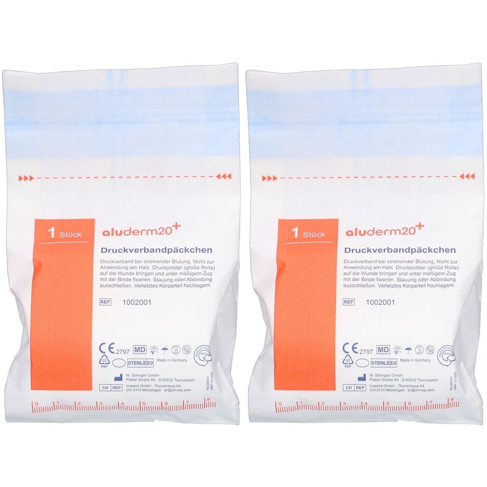 Zwei weiße Beutel mit blauer Oberseite. Aufdruck: aluderm20+, Druckverbandpäckchen, 1 Stück. Mit CE-Kennzeichnung.