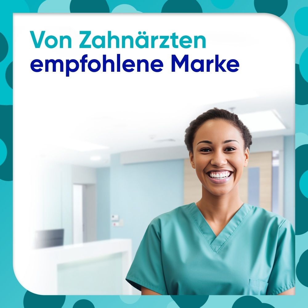 Zahnärztin in grüner Arbeitskleidung lächelt in die Kamera. Text: Von Zahnärzten empfohlene Marke.