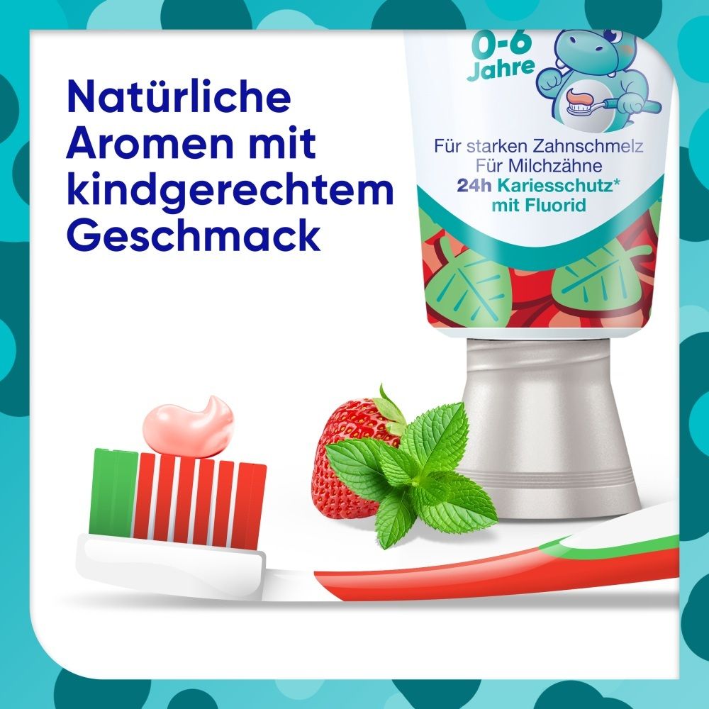Kinderzahnpasta mit Erdbeergeschmack, Zahnbürste und frischen Erdbeeren.