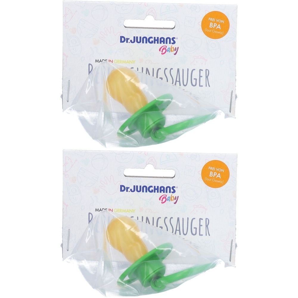 Zwei Schnuller in Verpackung. Gelber Sauger, grüner Schild. Aufschrift: Dr. Junghans Baby, BPA-frei.
