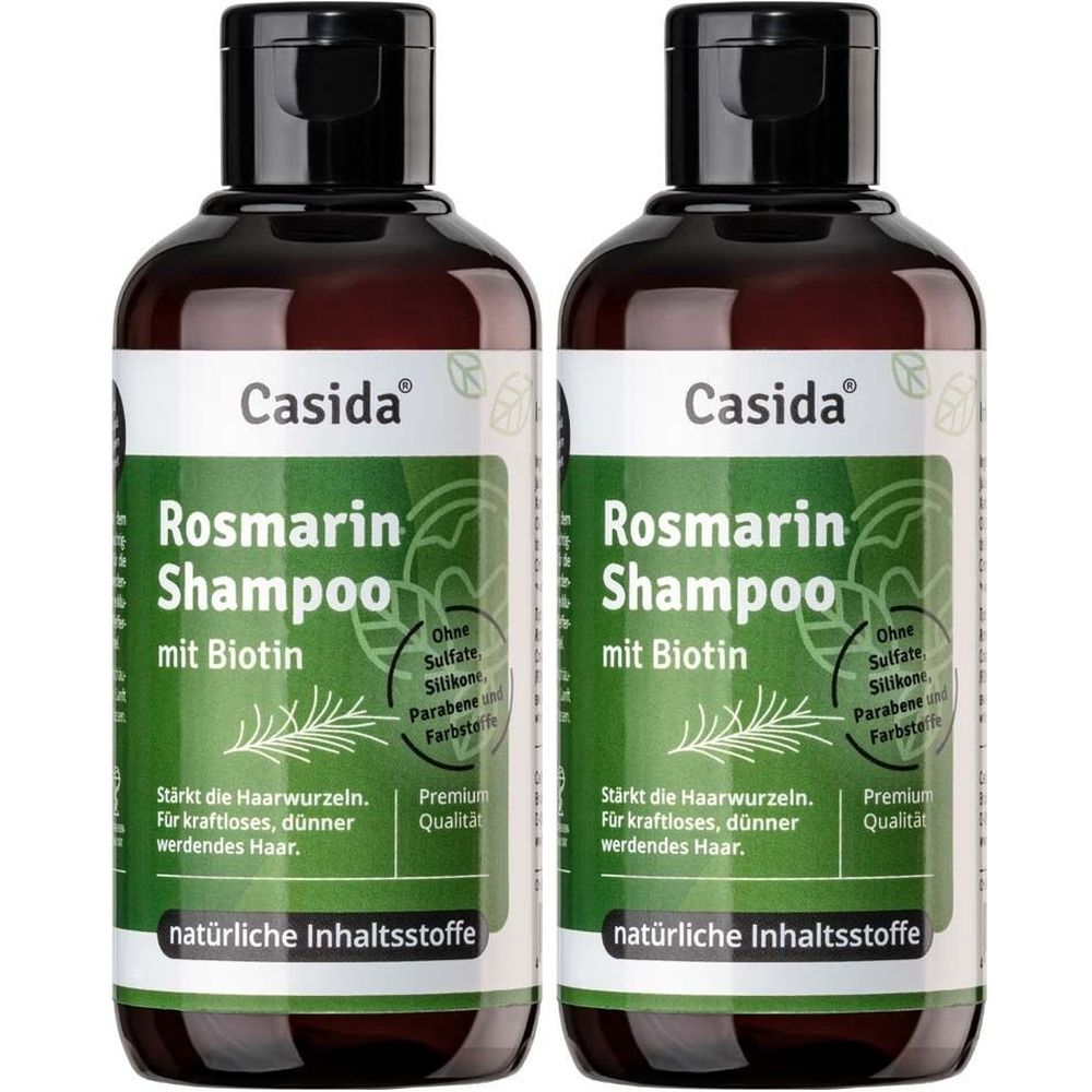 Zwei Flaschen Rosmarin Shampoo mit Biotin. Aufschrift: Casida, Rosmarin Shampoo, natürliche Inhaltsstoffe. Schwarzer Deckel, grüne Etiketten.
