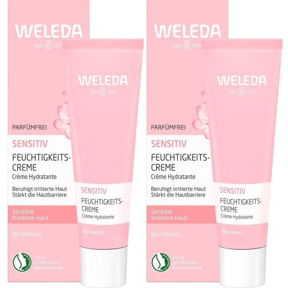 Zwei Tuben und Verpackungen von Weleda Sensitiv Feuchtigkeitscreme. Rosa Tuben und Verpackungen mit weißer Schrift.