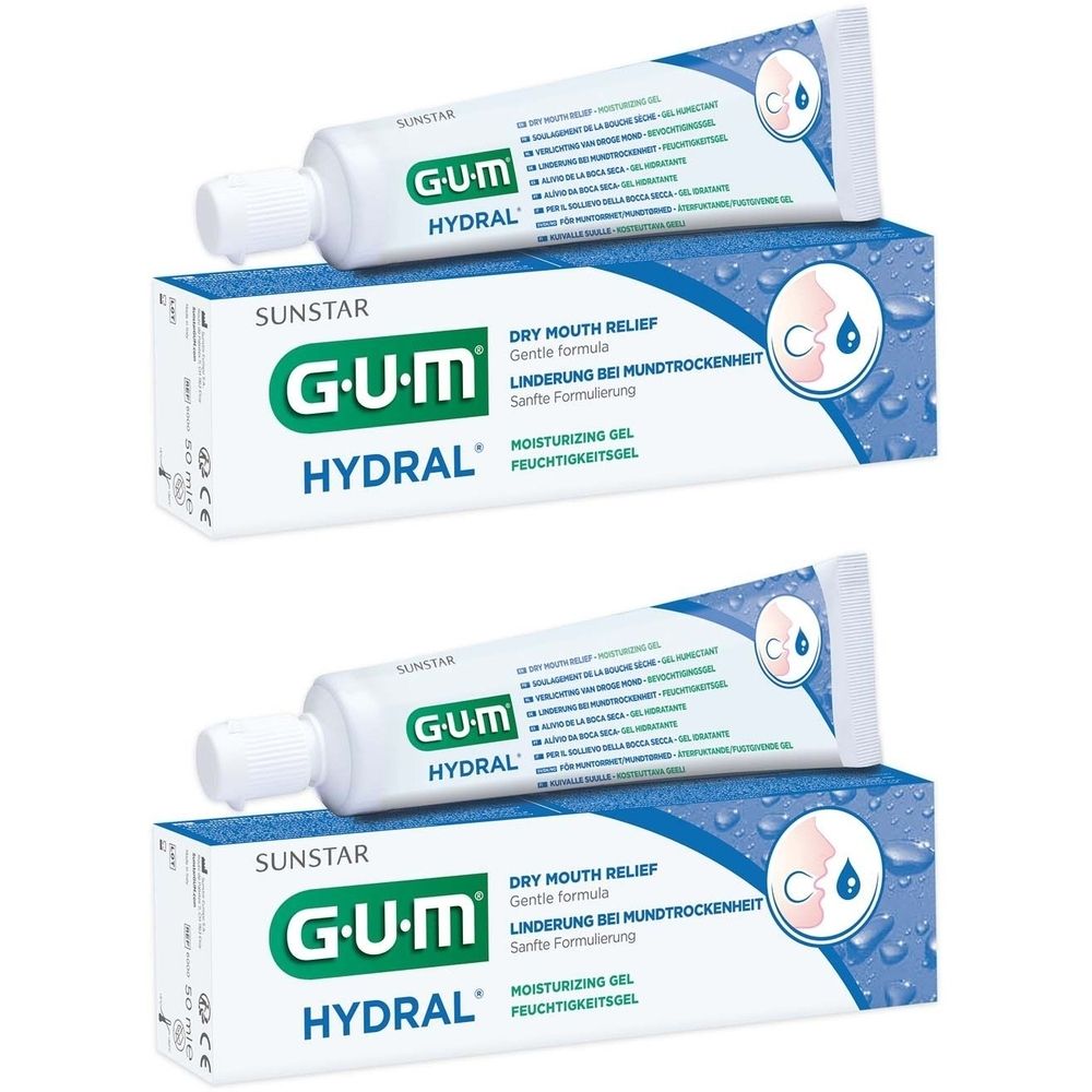 Zwei Tuben und zwei Kartons GUM Hydral Feuchtigkeitsgel. Weiße Tuben mit blauem Schriftzug. Kartons mit Produktnamen und Logo.