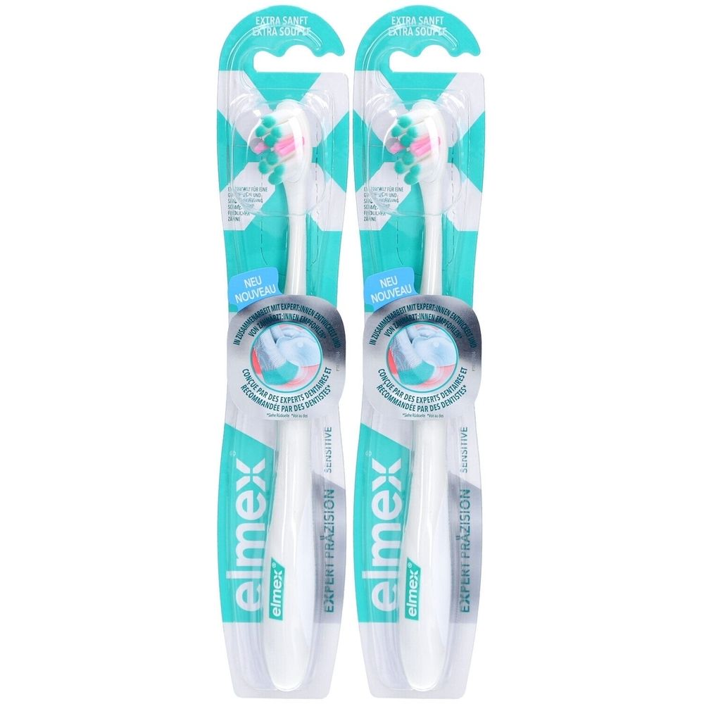 Zwei Zahnbürsten in Verpackung. Weiße Griffe, blaue und grüne Borsten. Aufschrift: elmex EXPERT PRÄZISION SENSITIVE.