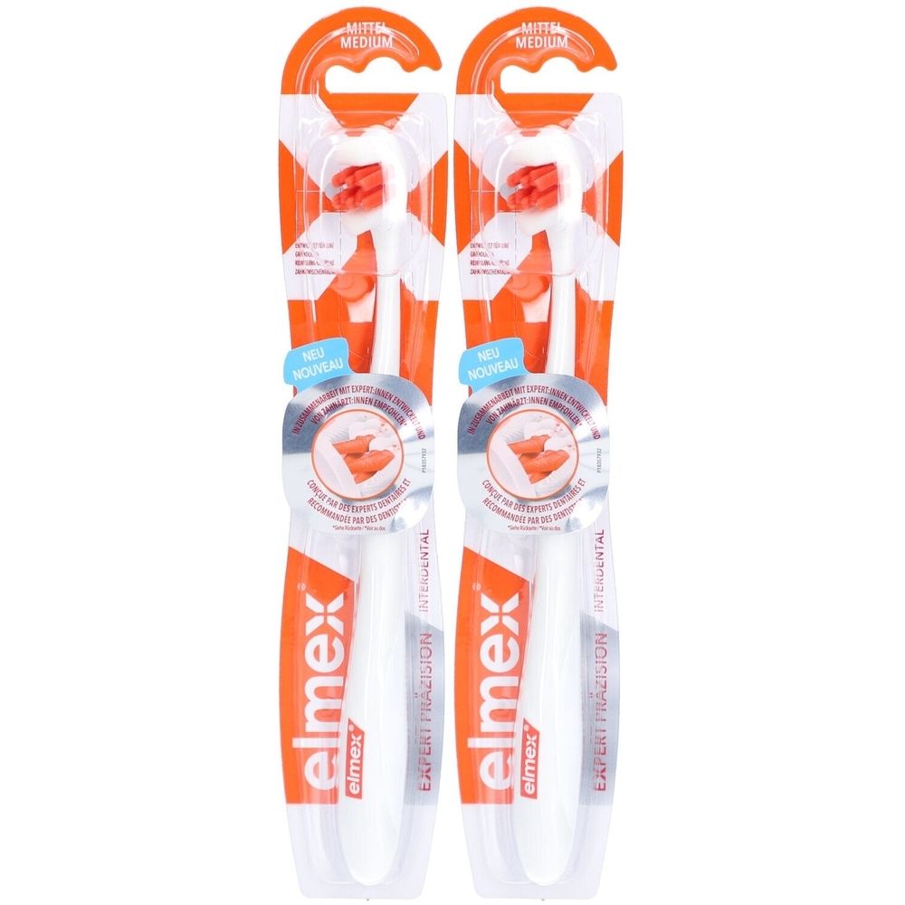 Zwei Zahnbürsten in Verpackung. Weiße Griffe, orangefarbene Borsten. Marke: elmex. Aufschrift: EXPERT PRÄZISION INTERDENTAL.