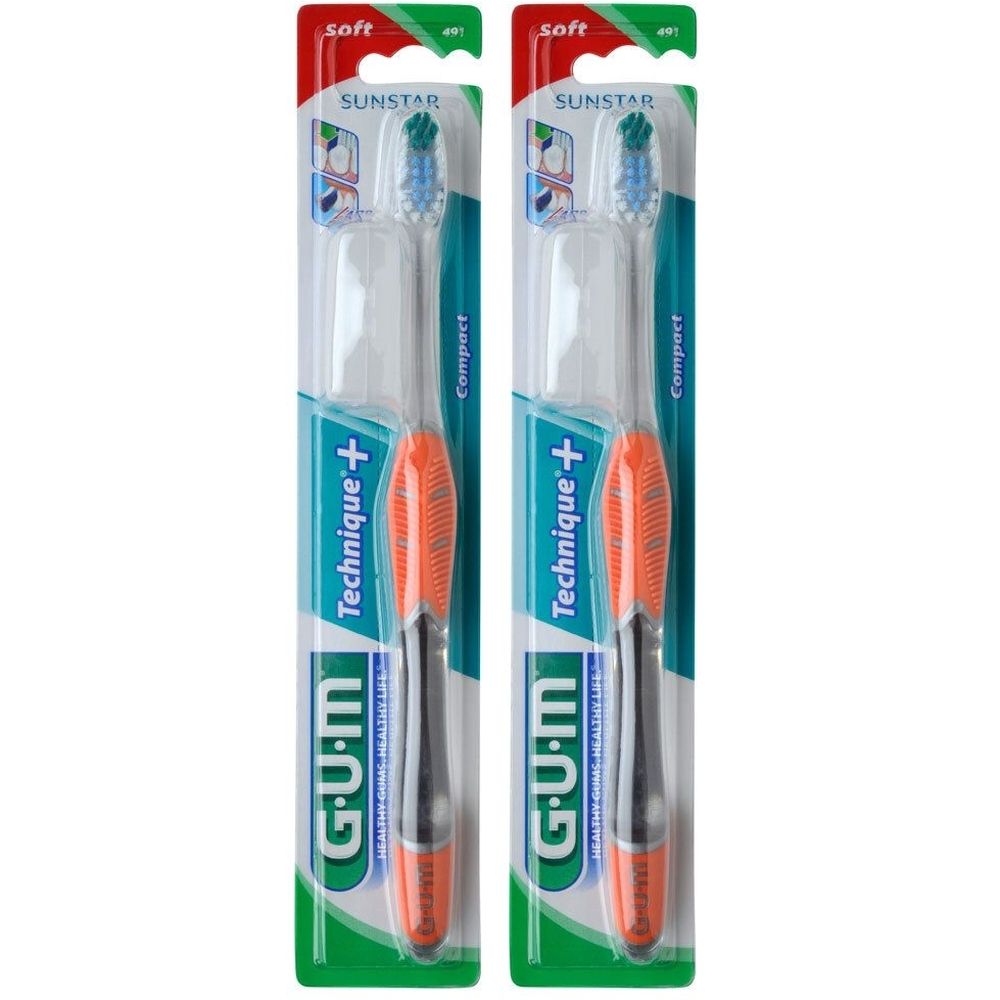 Zwei Zahnbürsten in Verpackung. Grüne, orange und schwarze Griffe. Aufschrift: GUM Technique+, SUNSTAR, soft, Compact.