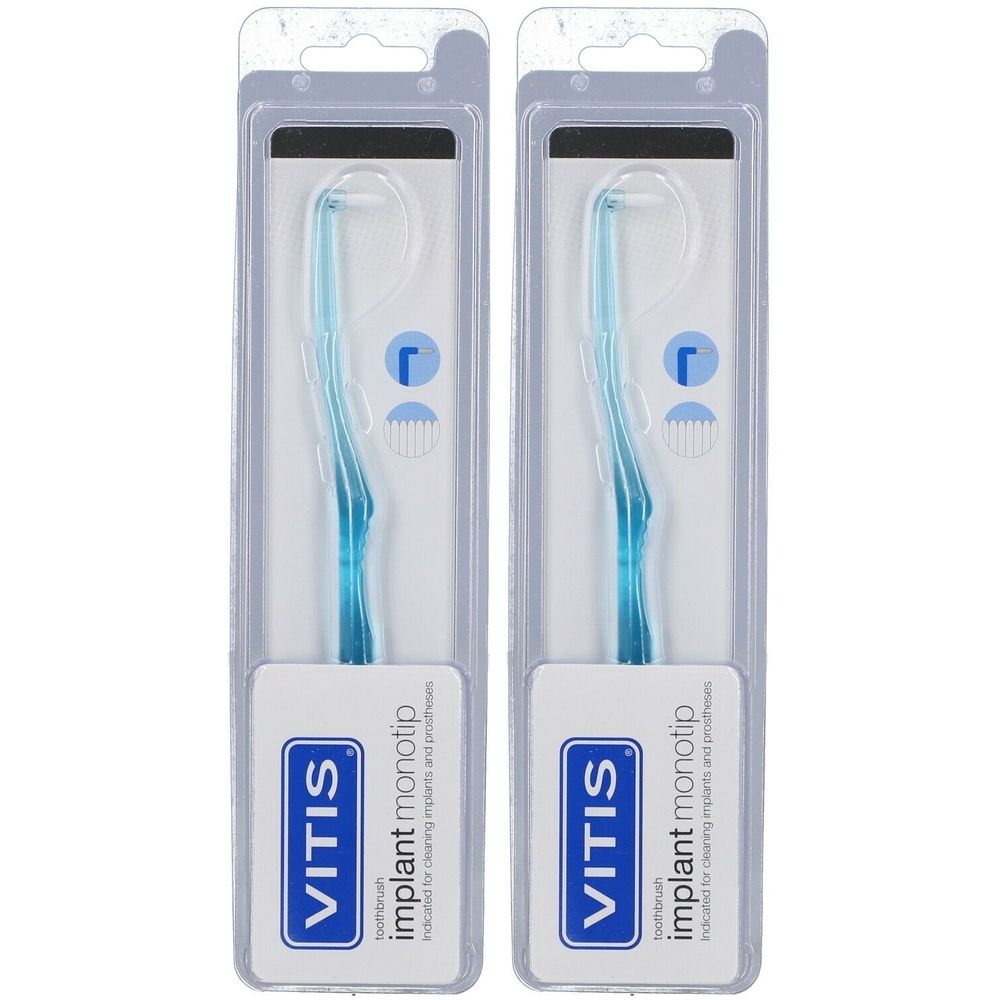 Zwei Zahnbürsten in Blisterverpackung. Blaue Griffe, abgewinkelte Bürstenköpfe. Marke VITIS, Aufschrift 'implant monotip'.