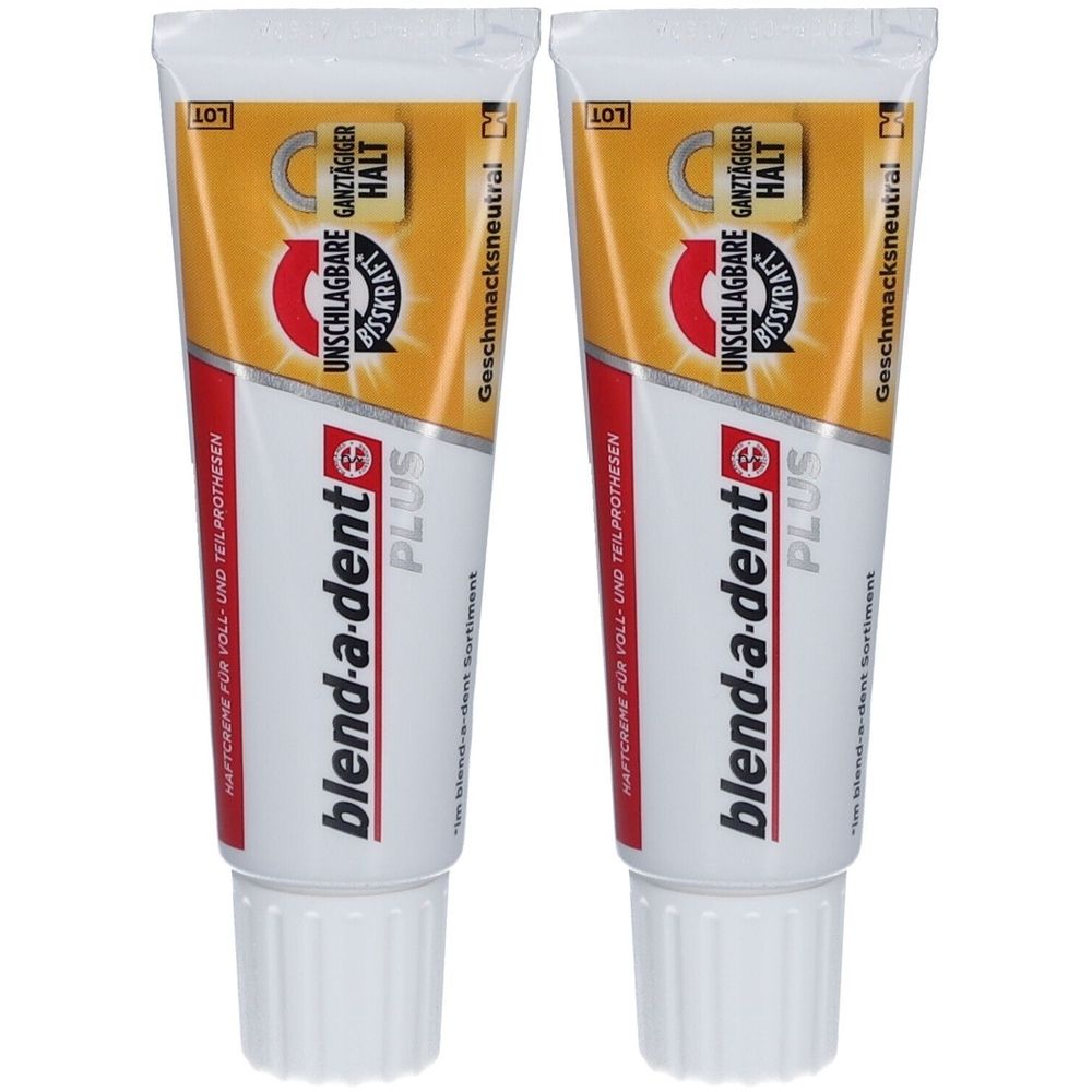 Zwei Tuben Haftcreme. Weiß, rot, gelb und silberfarben. Aufschrift: blend-a-dent PLUS, UNSCHLAGBARE BISSKRAFT, GANZTÄGIGER HALT.