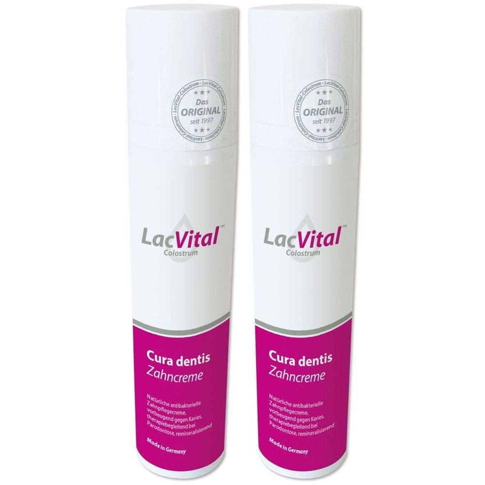 Zwei weiße Flaschen mit rosa Etiketten. Aufschrift: LacVital Colostrum Cura dentis Zahnpflegecreme. Oben: Das Original seit 1937.