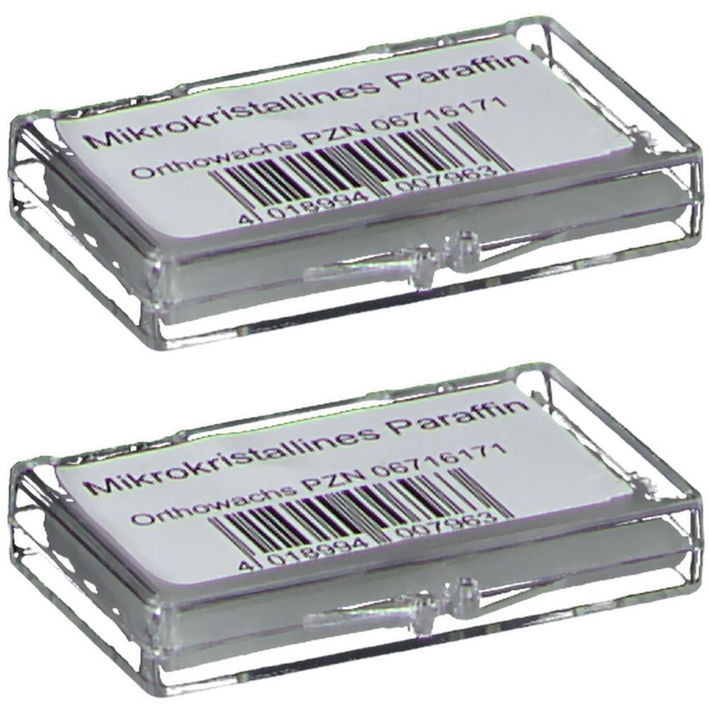 Zwei transparente Kunststoffboxen mit Etikett. Aufschrift: Mikrokristallines Paraffin, Orthowachs, PZN-Nummer und Barcode.