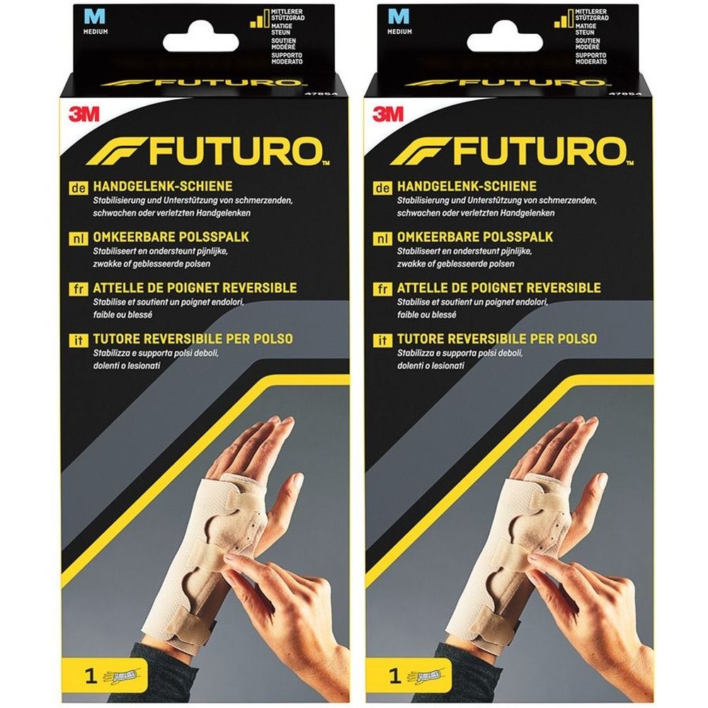 Zwei Produktverpackungen mit Handgelenk-Schiene. Marke FUTURO, Größe M. Aufschrift: Handgelenk-Schiene, OMKEEERBARE POLSSPALK, ATTELLE DE POIGNET REVERSIBLE.