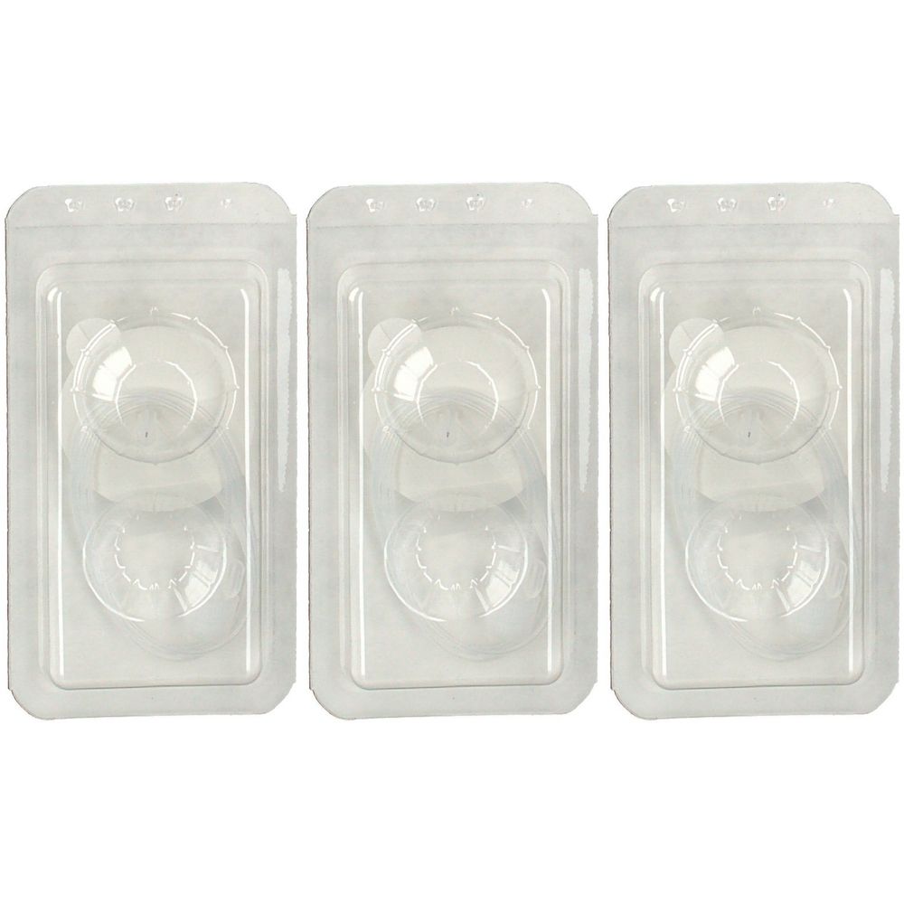 Drei transparente Kunststoffverpackungen mit medizinischen Komponenten. Jede Verpackung enthält zwei runde und eine ovale Form.