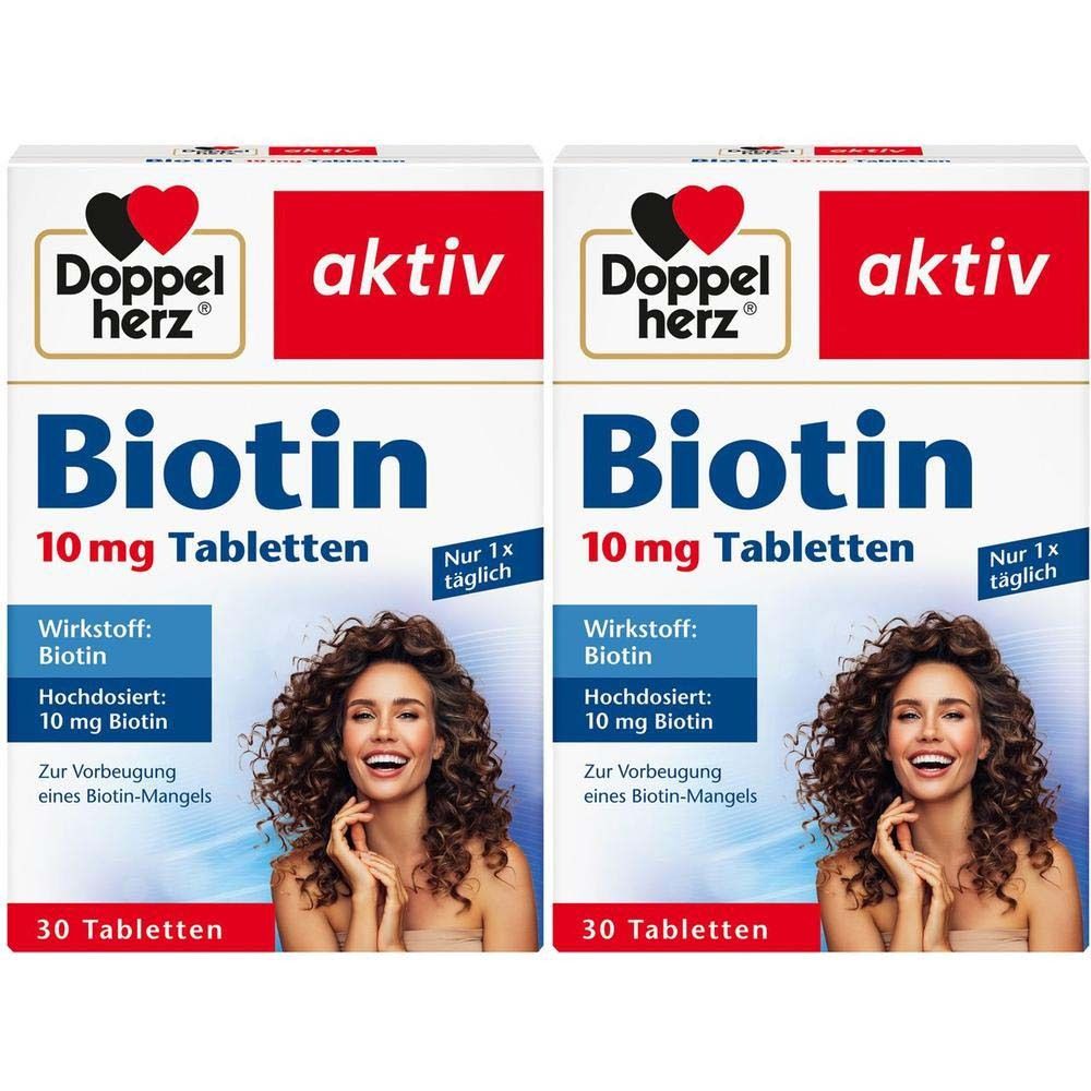 Zwei Packungen Doppelherz aktiv Biotin 10 mg Tabletten. Aufdruck: Biotin, 10 mg Tabletten, 30 Tabletten. Frau mit lockigem Haar.