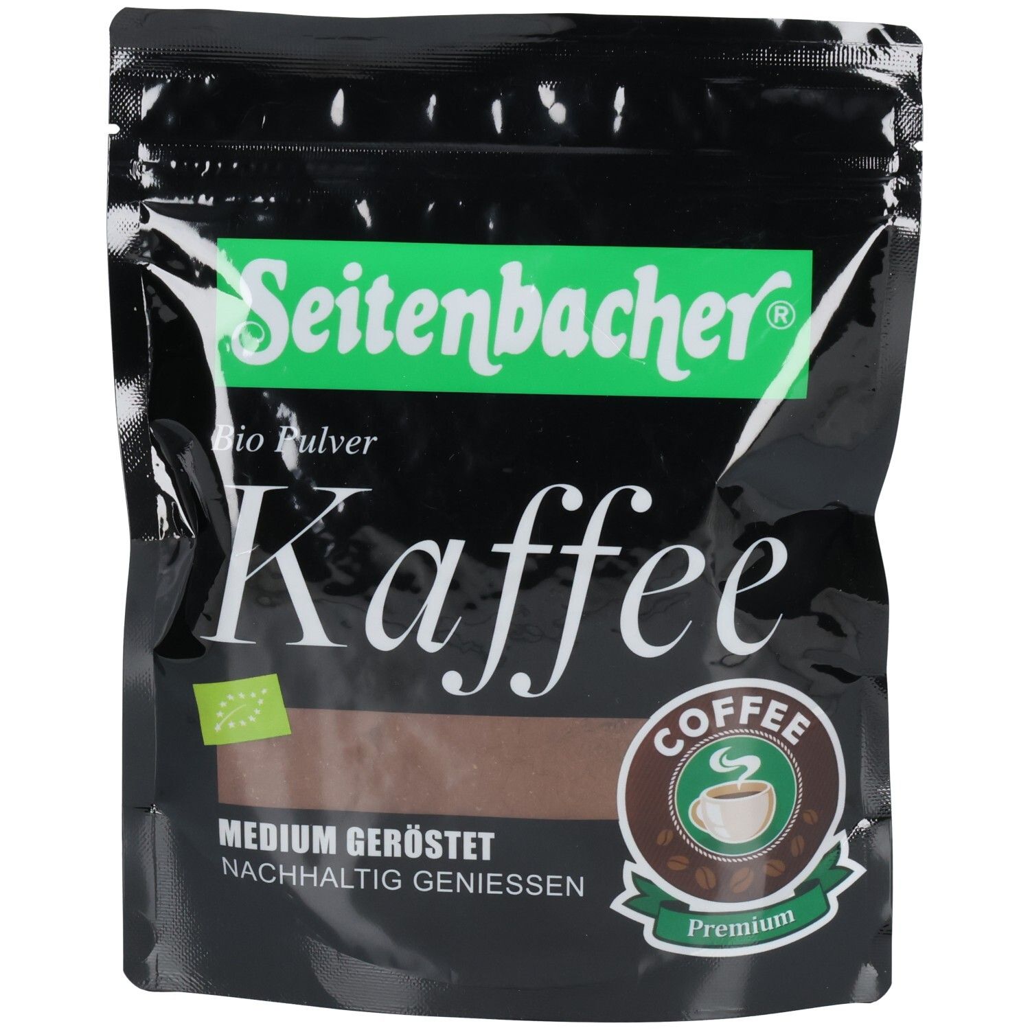 Schwarze Verpackung mit grünem Seitenbacher-Logo und Kaffeetext. Bio-Pulver-Kennzeichnung. Braunes Kaffee-Symbol. "Medium geröstet" Text.