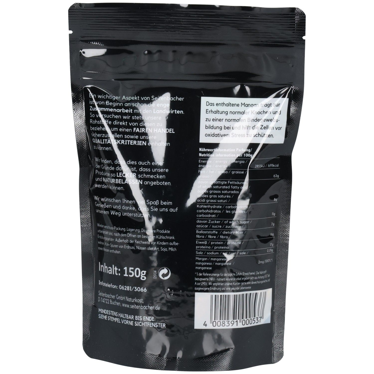 Rückseite der Verpackung mit Text und Nährwertangaben. Schwarzer Hintergrund. Text in Weiß.