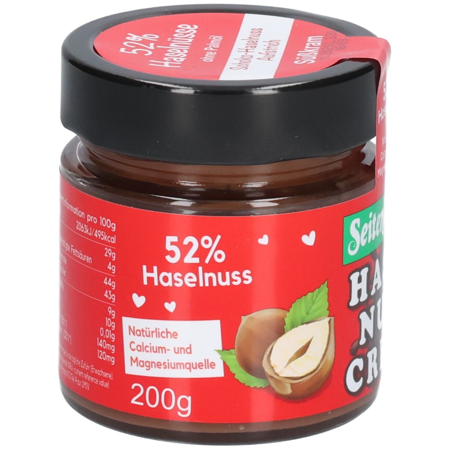 Glas mit Schoko-Haselnuss-Creme. Rote Etikett mit 52% Haselnuss und Nährwertangaben. Marke: Seitenbacher. 200g.