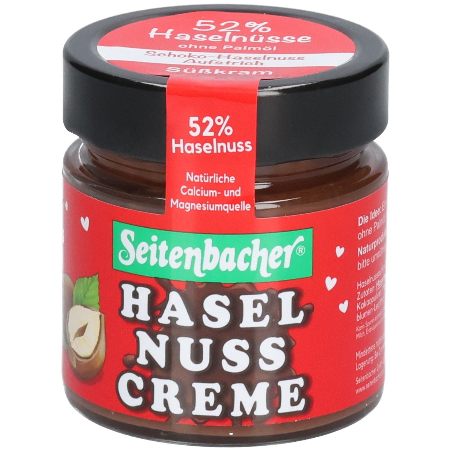 Glas mit Schoko-Haselnuss-Creme. Roter Aufkleber mit 52% Haselnuss. Marke: Seitenbacher. Schwarzer Deckel.