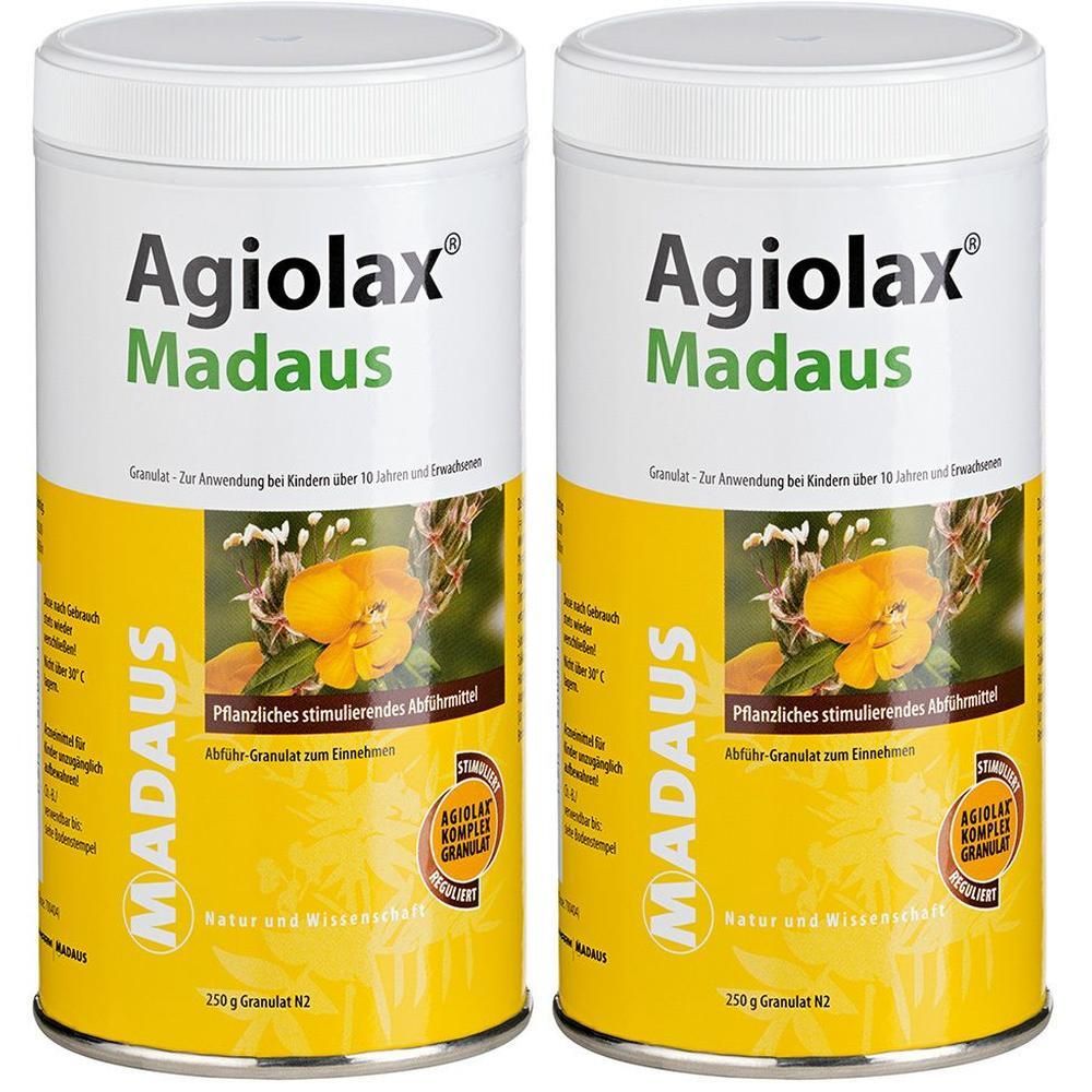 Zwei zylindrische Dosen mit weißem Deckel. Auf gelbem Hintergrund steht "Agiolax Madaus". Text und Abbildung einer gelben Blüte.
