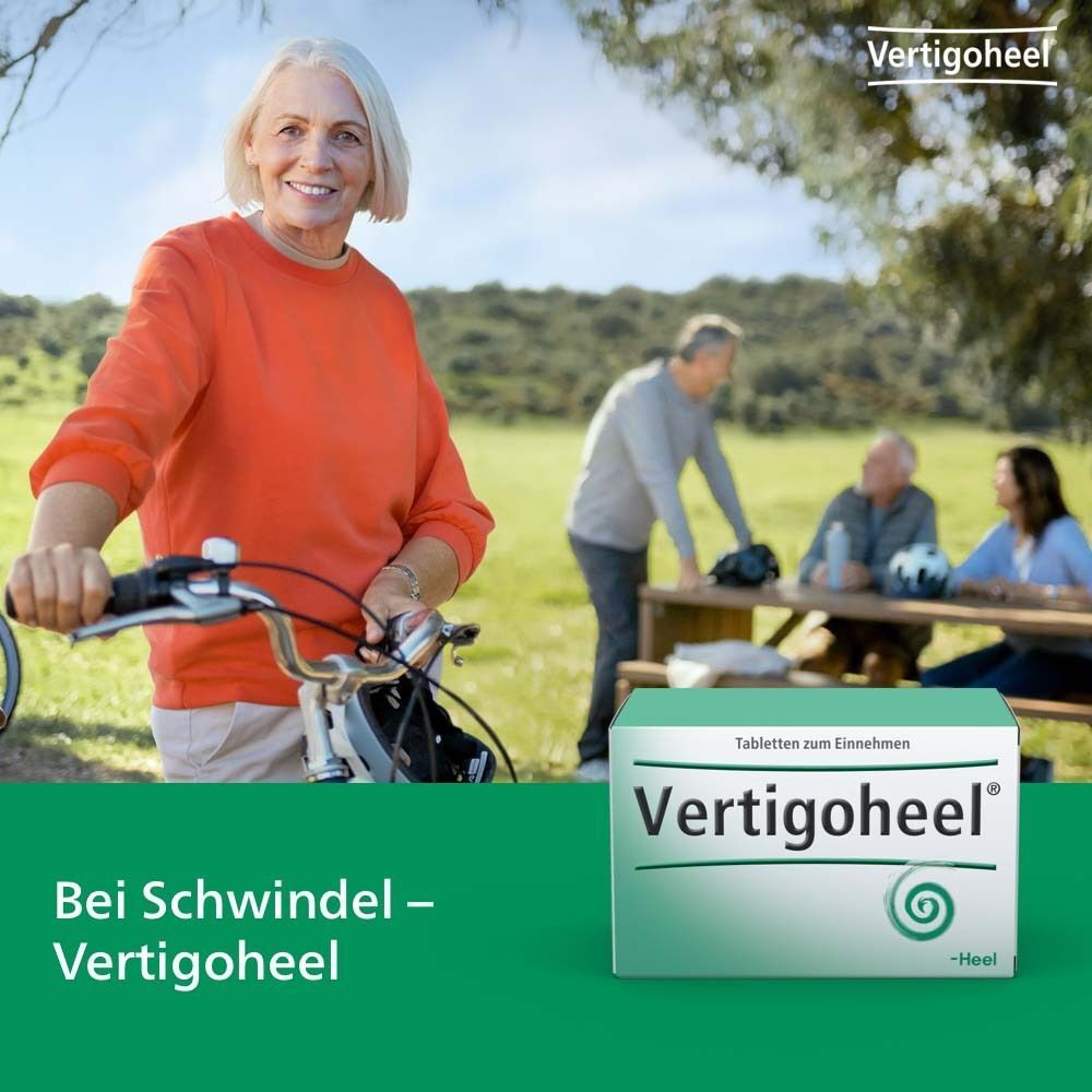 Frau lächelt und hält Fahrrad. Packung Vertigoheel® Tabletten. Text: Bei Schwindel - Vertigoheel.