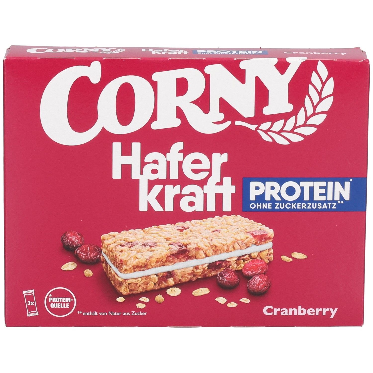 Rote Schachtel Corny Haferkraft Protein Cranberry. Abgebildet: Riegel, Cranberries und Haferflocken. Text: Protein, ohne Zuckerzusatz.