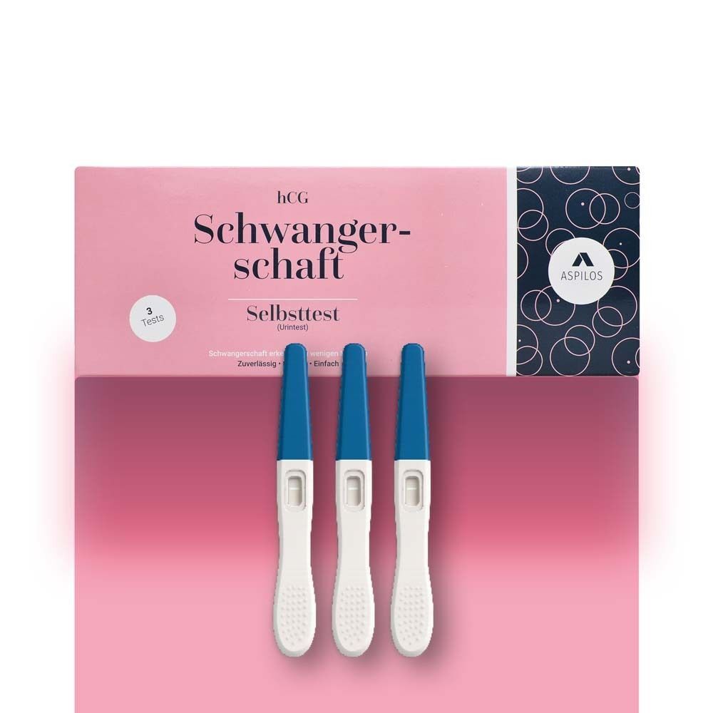 Rosa Schachtel mit 'Schwangerschaft Selbsttest' und drei Teststäbchen mit blauen Kappen.