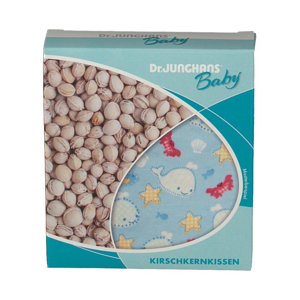 Rechteckiger Karton mit Kirschkernkissen. Aufdruck: Dr. Junghans Baby. Kissen mit blauem Stoff und Wal-Motiv. Text: Kirschkernkissen.
