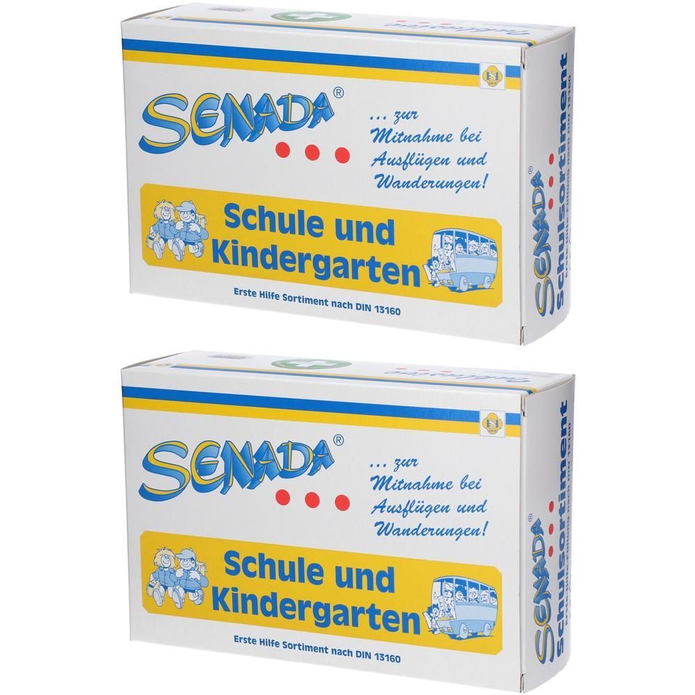 Zwei weiße Kartons mit SENADA-Logo und Aufschrift 'Schule und Kindergarten'. Erste-Hilfe-Sortiment nach DIN 13160.