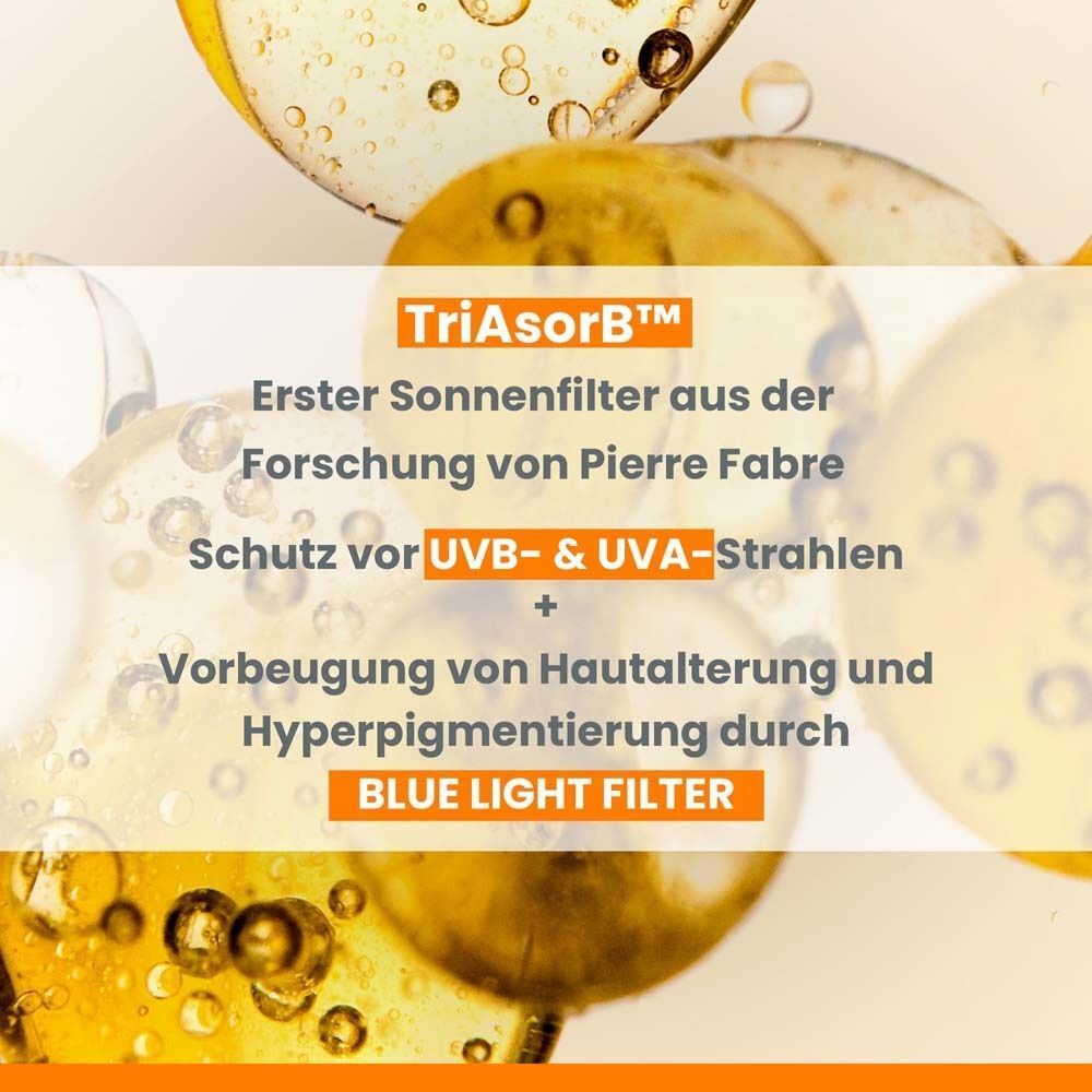 Nahaufnahme von gelben Flüssigkeiten mit Text: TriAsorb, Schutz vor UVB- & UVA-Strahlen, Blue Light Filter.