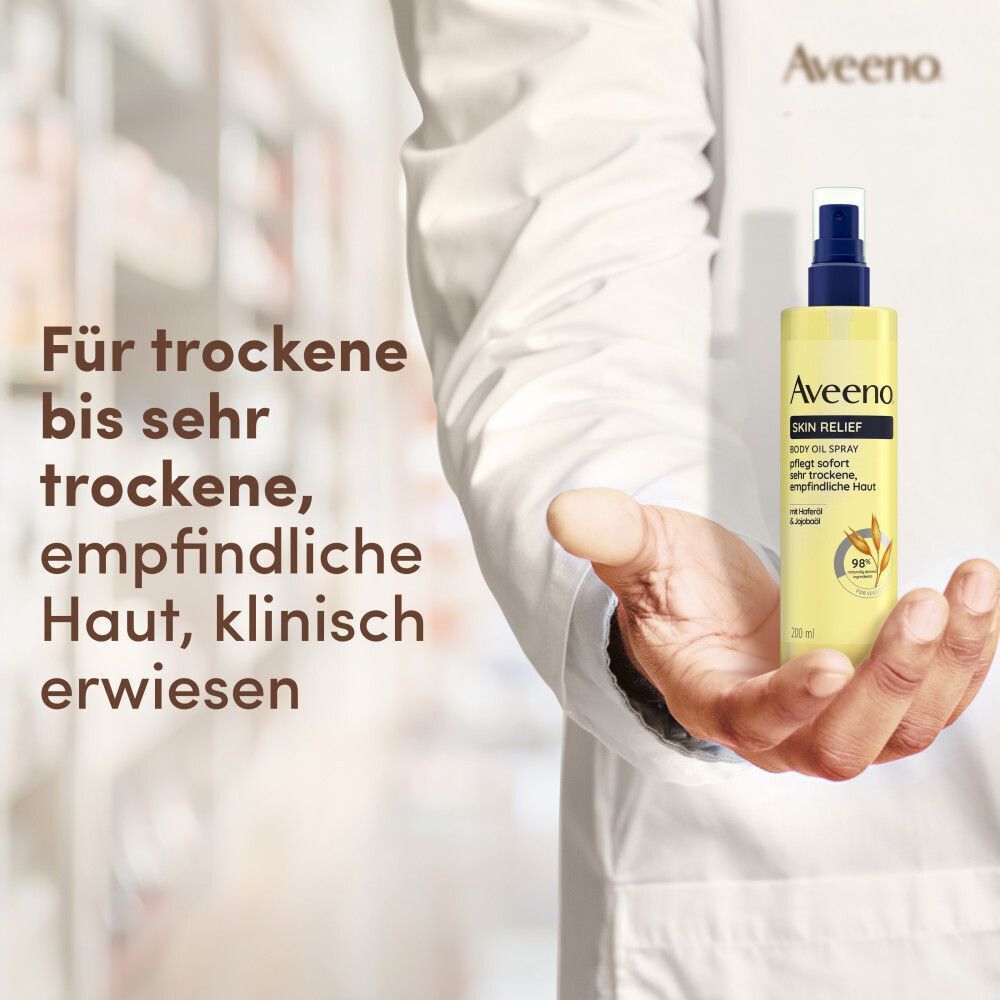Gelbe Sprühflasche mit blauem Verschluss. Aufschrift: Aveeno Skin Relief Body Oil Spray. Text: Für trockene bis sehr trockene, empfindliche Haut, klinisch erwiesen.