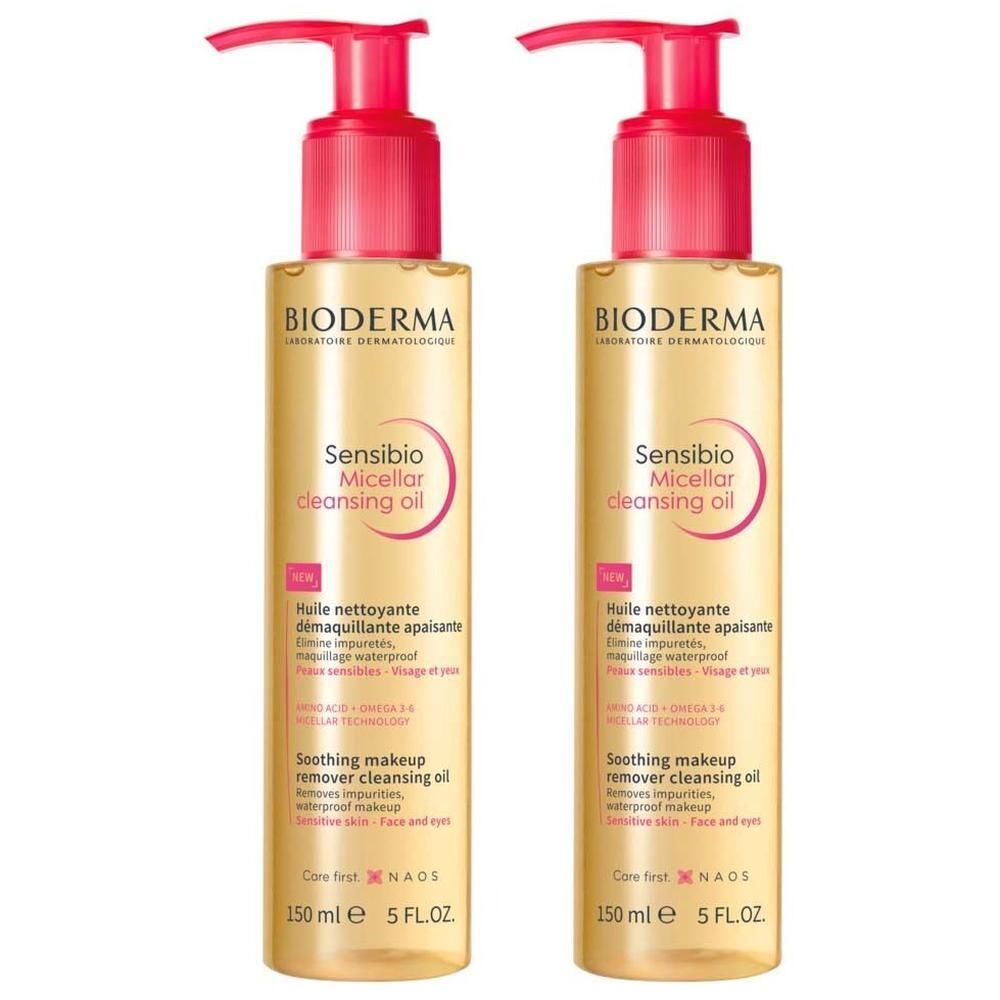 Zwei Flaschen BIODERMA Sensibio Mizellenreinigungsöl mit rosa Pumpaufsatz. Gelbe Flüssigkeit, Produktbeschriftung.