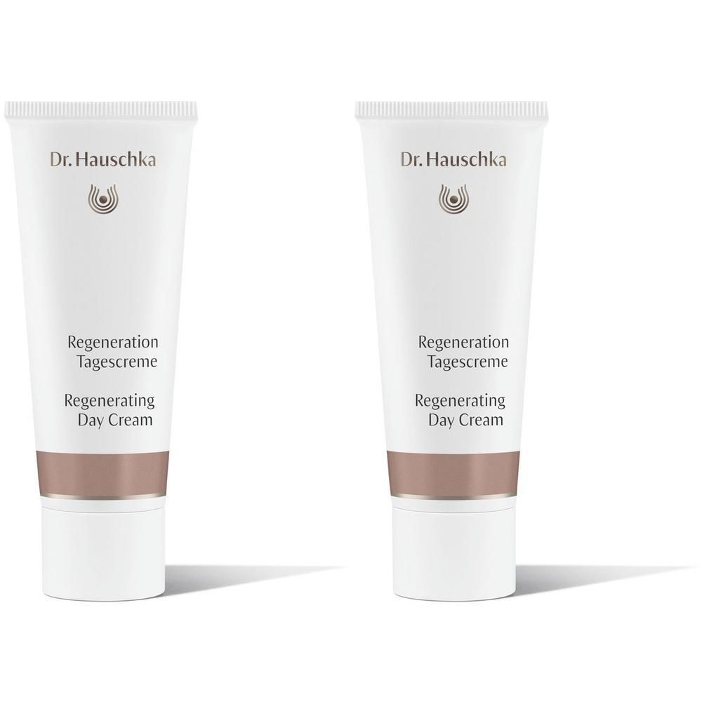 Zwei weiße Tuben Dr. Hauschka Regeneration Tagescreme mit silbernem Band.