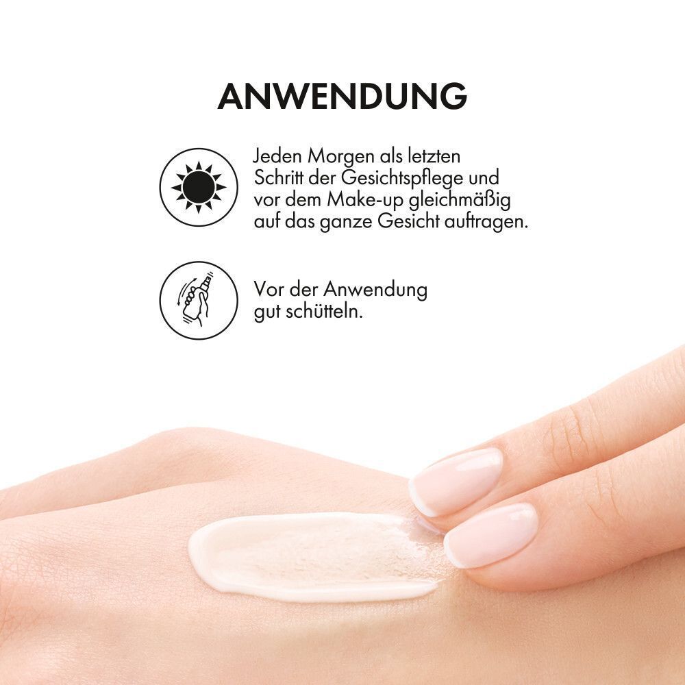 Hand mit Creme. Anwendungshinweise: Morgens vor dem Make-up auftragen. Vor Gebrauch schütteln.