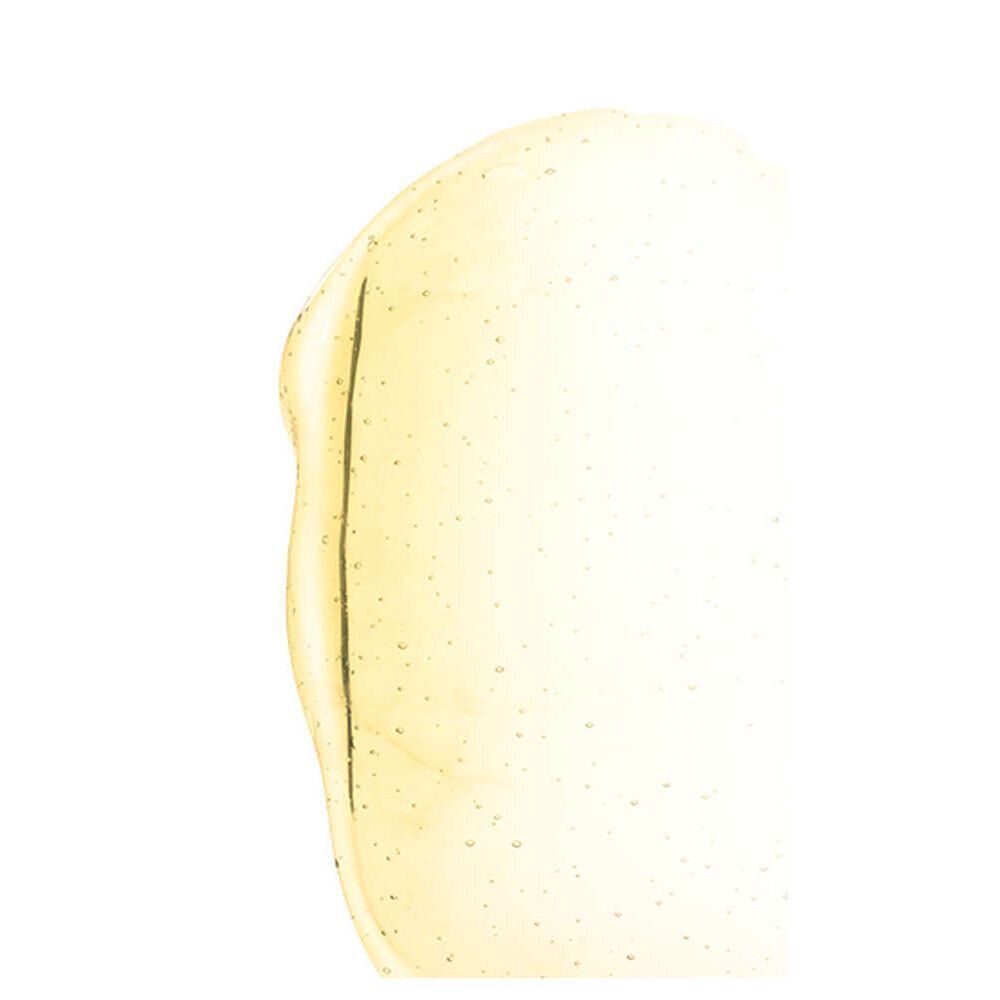 Gelartige Substanz, gelblich, mit kleinen Partikeln. Auf weißem Hintergrund. Geformt wie ein Tropfen.