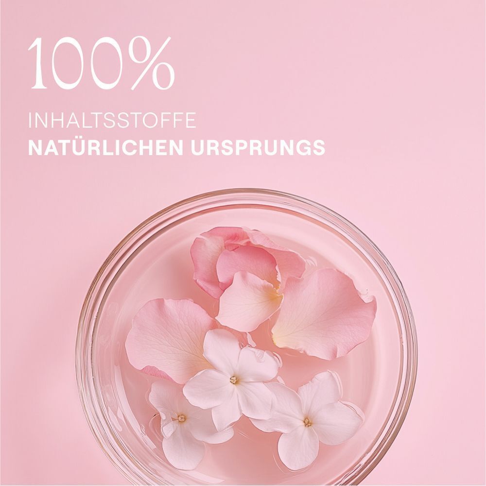 Blütenblätter und Blüten in einer Glasschale. Text: 100% Inhaltsstoffe natürlichen Ursprungs.