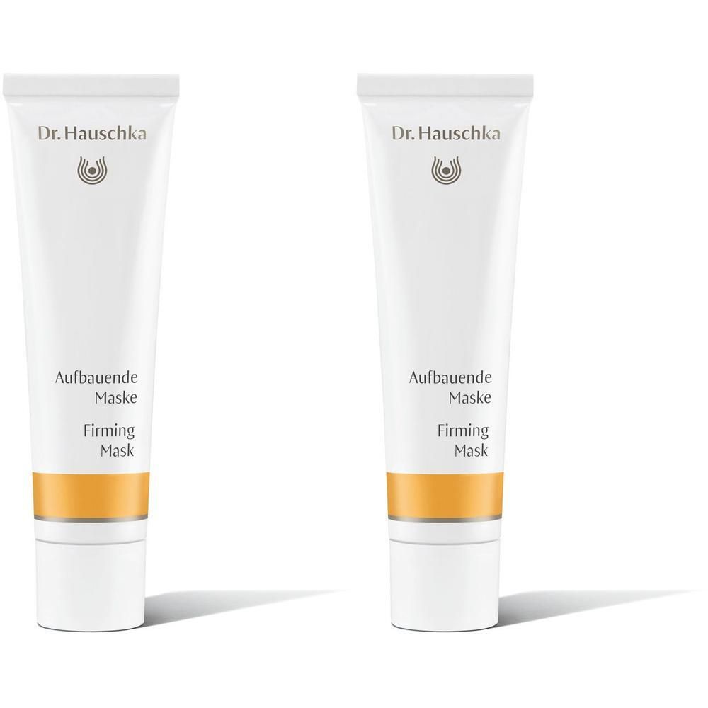 Zwei weiße Tuben Dr. Hauschka Aufbauende Maske mit goldfarbenem Band.