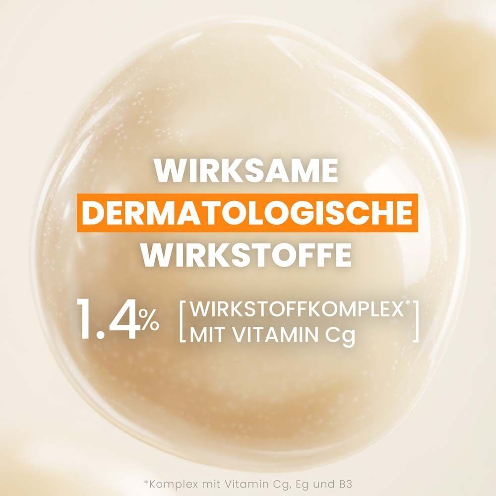 Nahaufnahme einer Flüssigkeit. Text: Wirksame dermatologische Wirkstoffe, 1,4% [Wirkstoffkomplex] mit Vitamin Cg.