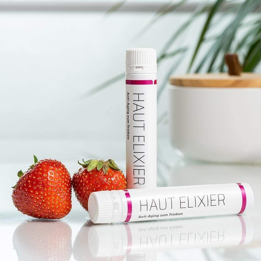 Zwei Trinkampullen Sanhelios Haut Elixir und Erdbeeren. Weiß mit pinkfarbenen Akzenten. Text: Haut Elixir, Anti-Aging zum Trinken.