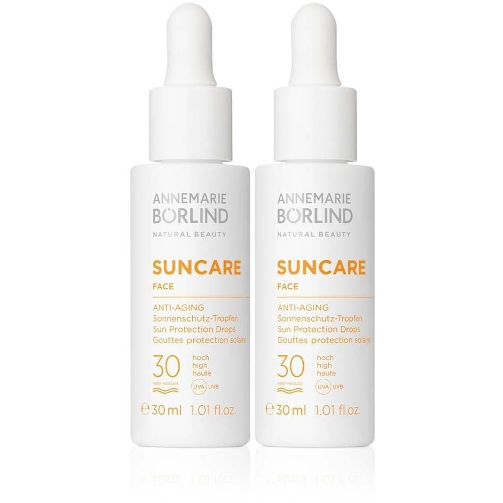 Zwei weiße Flaschen mit Tropfaufsatz. Aufschrift: Suncare Face, LSF 30. Marke: Annemarie Börlind.