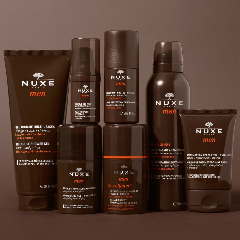 Verschiedene NUXE men Produkte. Duschgel, After-Shave, Deodorant-Roller, Rasierbalsam, Shampoo. Braune Verpackungen.