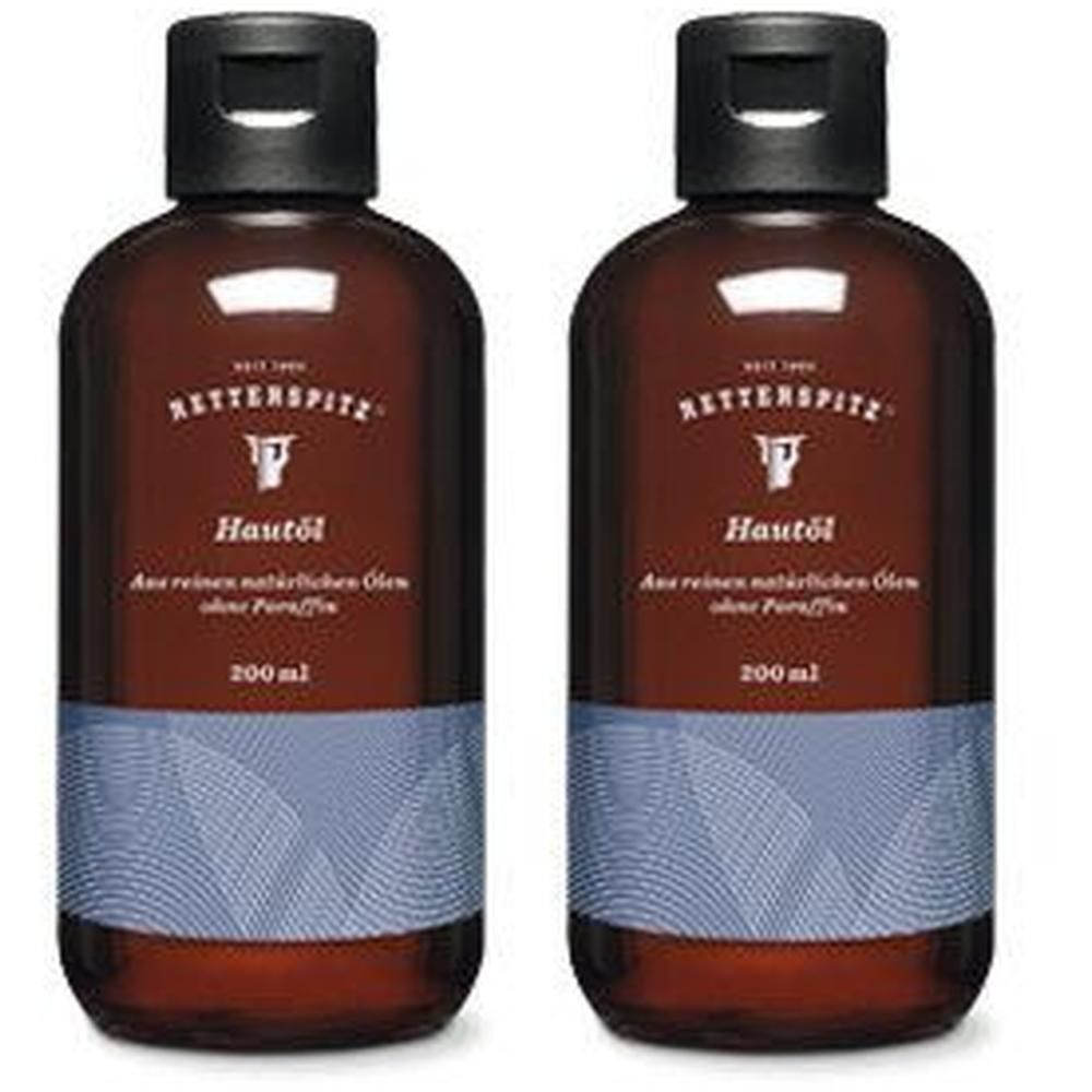 Zwei braune Flaschen mit schwarzem Verschluss. Aufschrift: RETTERSPITZ, Hautöl, 200 ml. Blaue und weiße Musterung am unteren Teil.