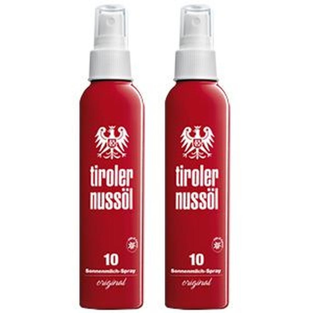 Zwei rote Sprühflaschen mit weißem Aufsatz. Aufschrift: Tiroler Nussöl, 10, Sonnenmilch-Spray, original. Logo: Adler.