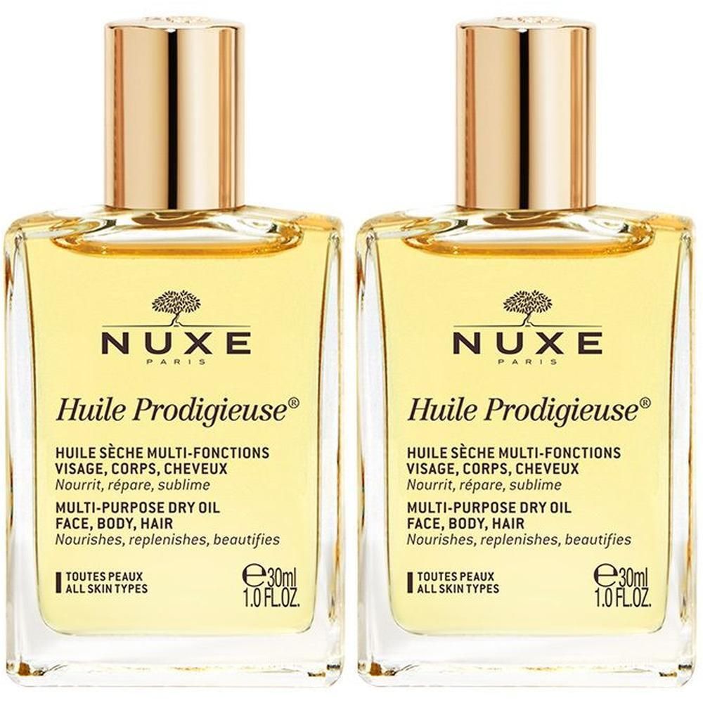 Zwei Flakons mit goldfarbenen Deckeln. Aufschrift: NUXE Huile Prodigieuse, Multi-Funktionen, Gesicht, Körper, Haar.