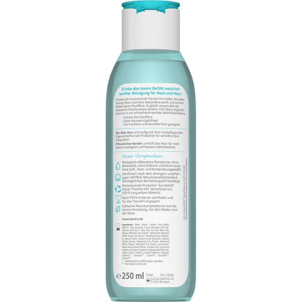 Rückseite einer Flasche lavera BASIS SENSITIV Pflegedusche 2in1. Text auf weißem Etikett, grüne Blätter-Logo, vegan, 250 ml.