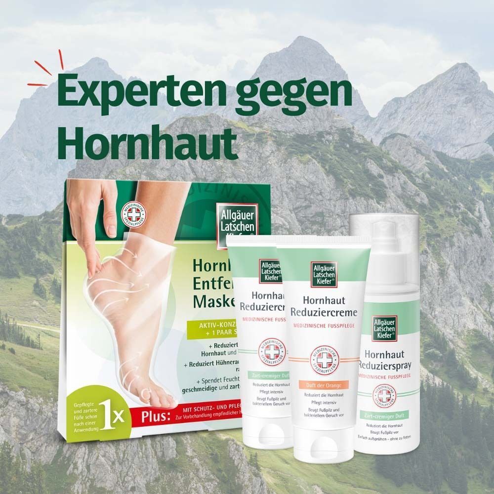 Produktreihe Hornhautpflege: Maske, Creme, Spray. Verpackungen mit Logo und Produktinformationen. Berge im Hintergrund.