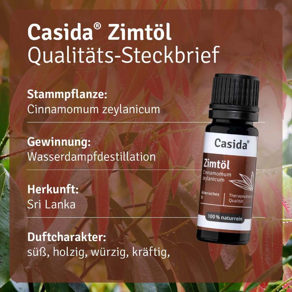 Eine Flasche Casida Zimtöl vor einem Hintergrund mit Blättern. Textinformationen über die Eigenschaften des Produkts.