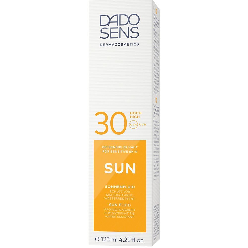 Weiße Verpackung für DADO SENS Sonnenfluid 30 mit orangefarbener Front.